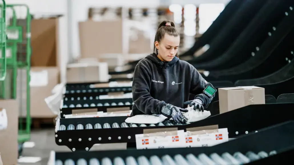 An operator loading parcels onto the HS sortation line at DNMH