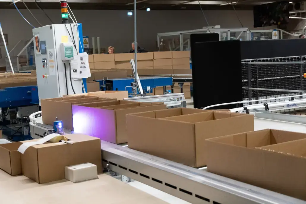 Printers above a conveyor printing menus for meal-kit boxes at Godt Levert