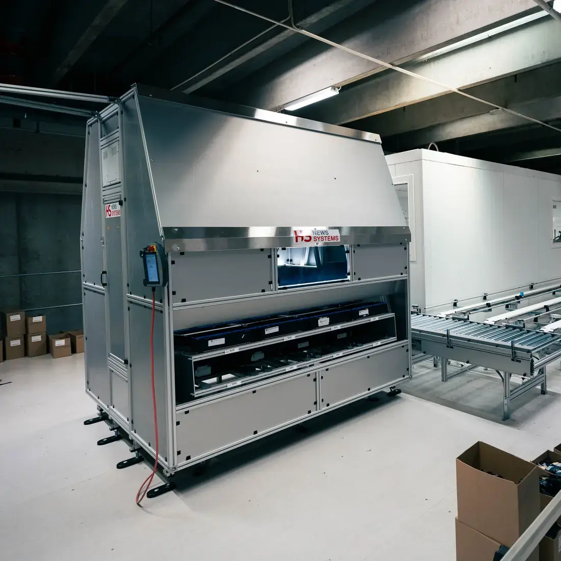 The enclosed HS pick robot cell next to a conveyor at Cheffelo